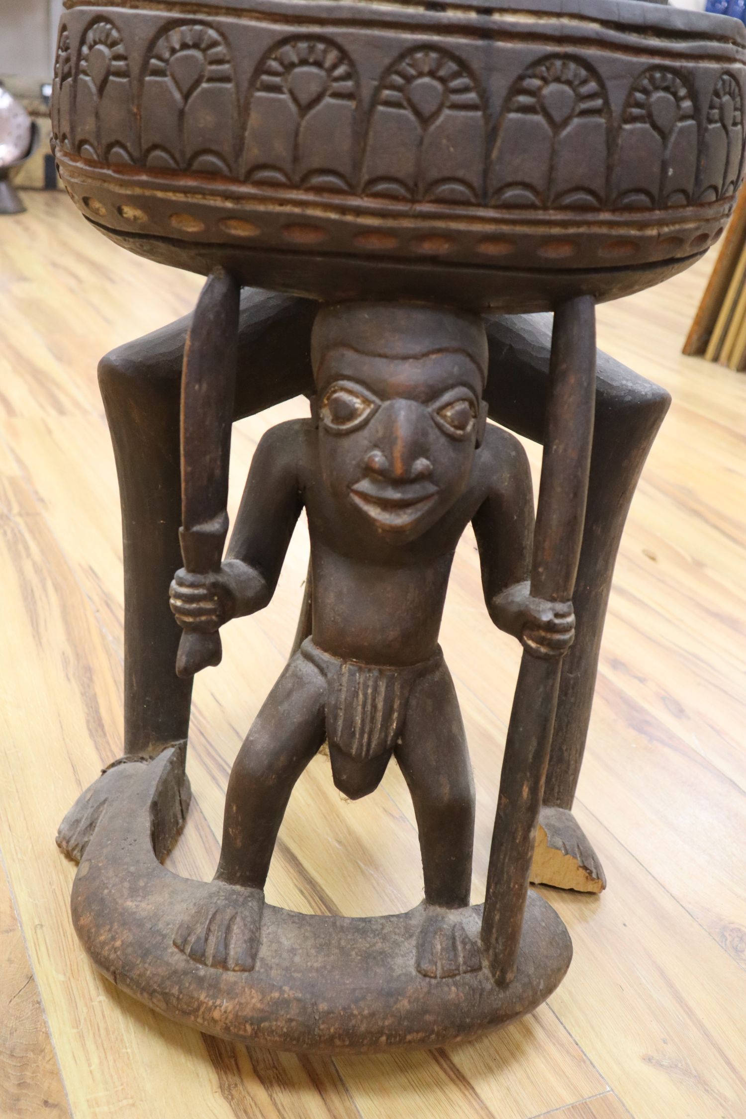 A large Bamileke carved wood figural storage vessel, Cameroon, length 109cm